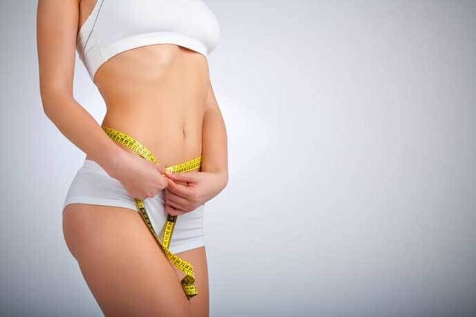 Slender girl measure waist volume